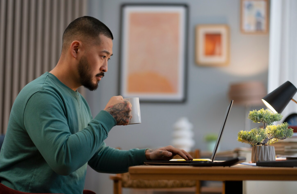 Man working remotely at a laptop in a cozy home office, illustrating global labor market trends in 2025.
