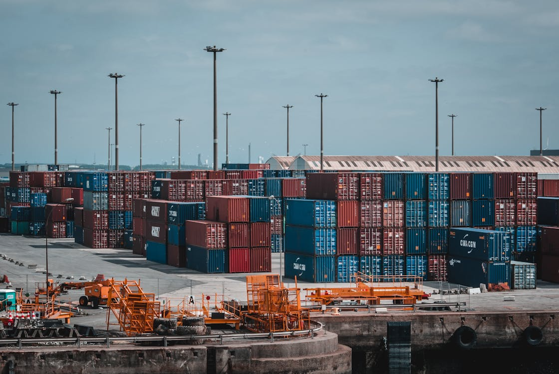 Stacks of shipping containers at an industrial port representing global supply chain resilience.