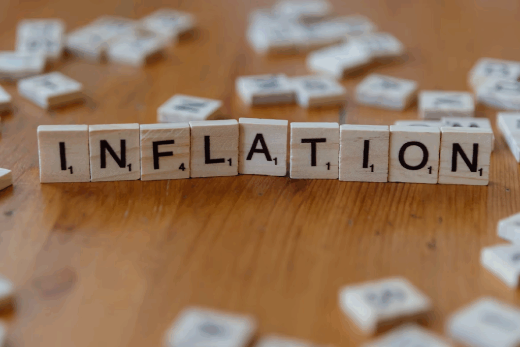 Wooden letter tiles spelling “inflation” on a table, illustrating global inflation trends.