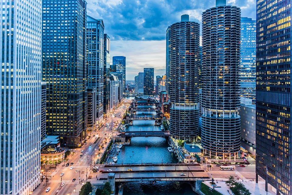 Aerial view of a modern city skyline and river at dusk, symbolizing rapidly growing financial hubs.