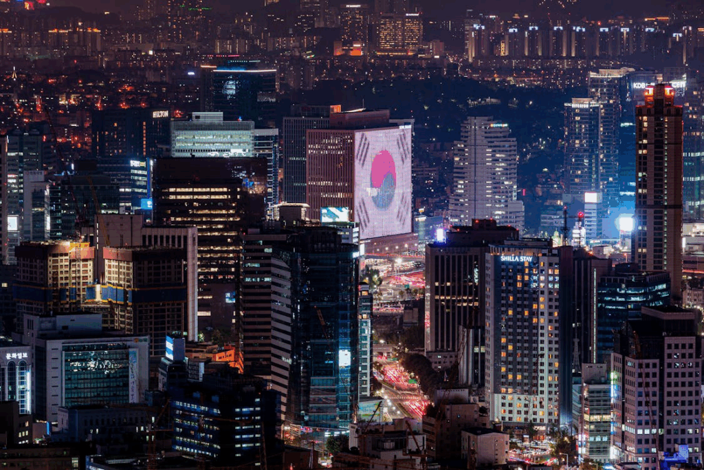 Night view of Seoul’s high-rise skyline with illuminated buildings, highlighting the city as an emerging global tech hub.